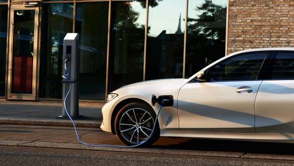 Plug-in hybrid BMW 3 Series Saloon 2021 G20 side view Plug-in hybrid BMW 3 Series Saloon 2021 G20 side view on charging station