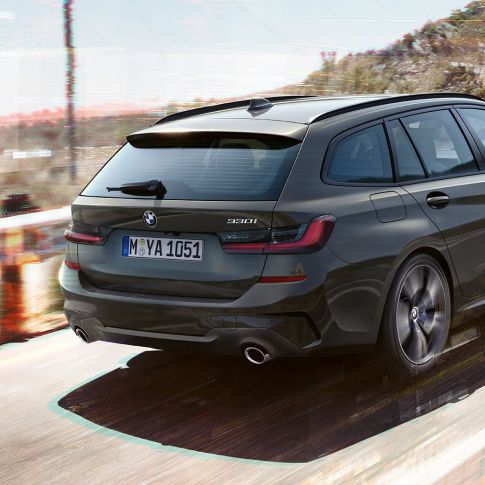 BMW 3 Series Touring, three-quarter rear shot BMW 3 Series Touring, three-quarter rear shot driving on bridge in front of rural surroundings
