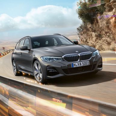 BMW 3 Series Touring, three-quarter front shot design BMW 3 Series Touring, three-quarter front shot driving on bridge in front of rural surroundings