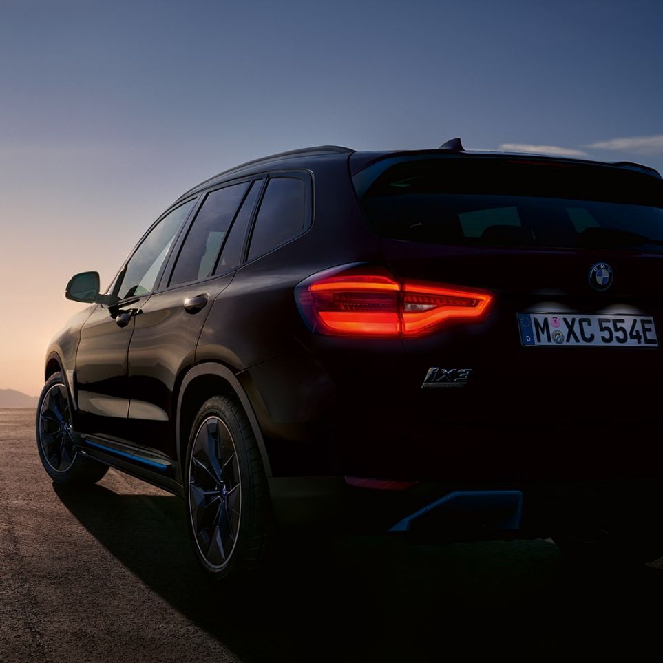 BMW iX3 G08 2020 High-gloss black three-quarter rear view on road BMW iX3 G08 2020 High-gloss black three-quarter rear view on road