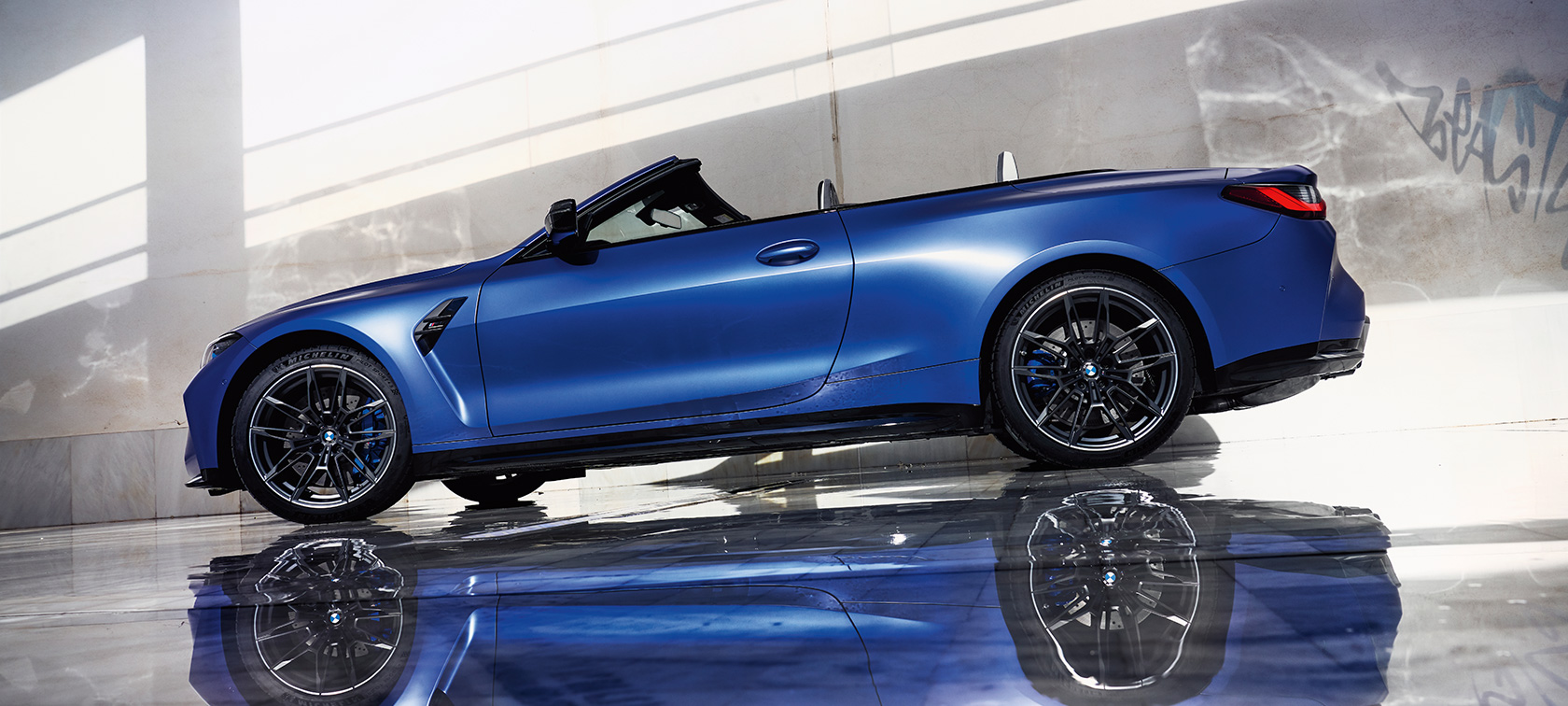 BMW M4 Competition Convertible with M xDrive G83 2021 side view low angle shot BMW M4 Competition Convertible with M xDrive G83 2021 BMW Individual Frozen Portimao Blue metallic side view standing low angle shot