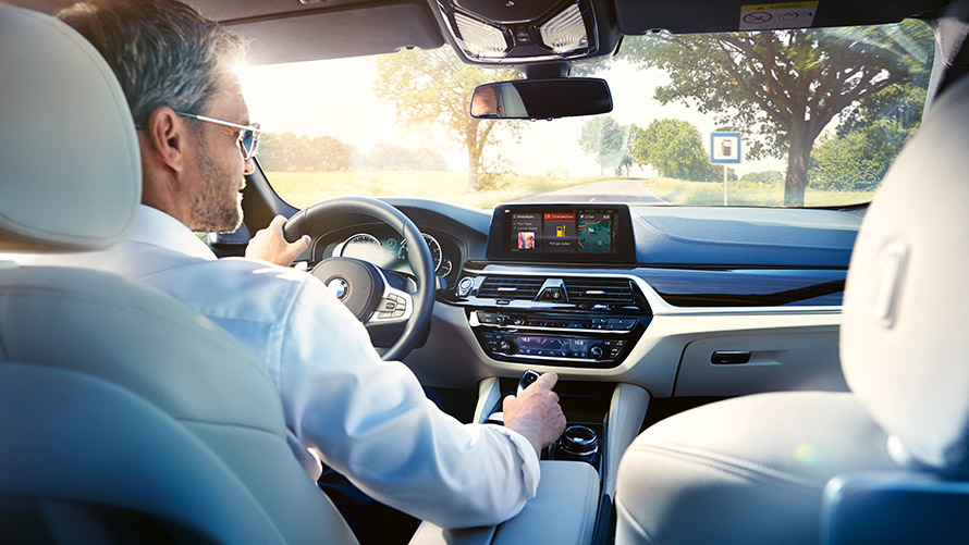 BMW Connected app Man using BMW Connected app in car.