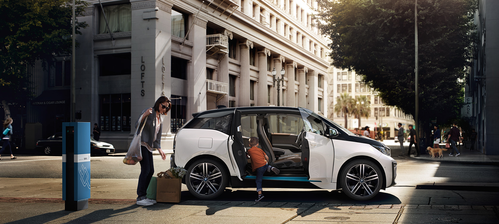 BMW i3 against an urban backdrop BMW range BMW i3 against an urban backdrop with woman and child