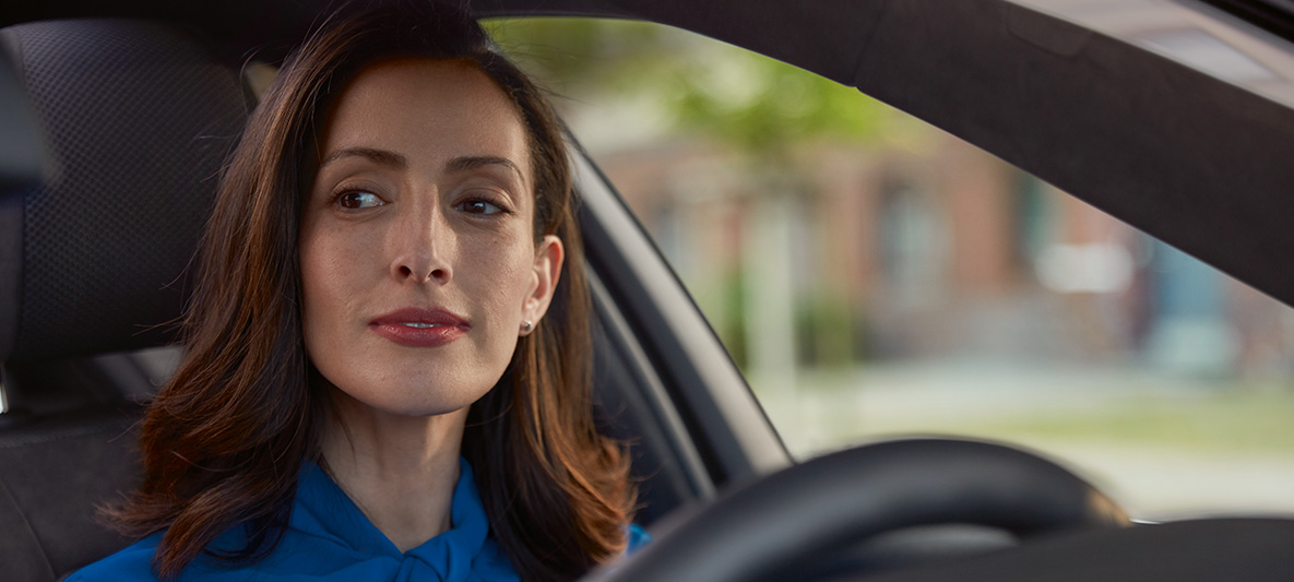 Woman looking to the side while driving