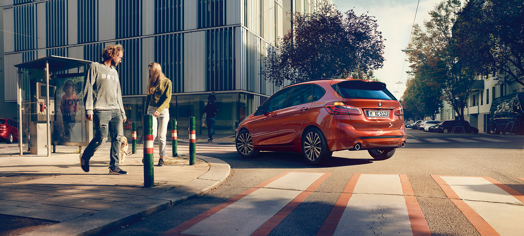 Driving dynamics BMW 2 Series Active Tourer Driving dynamics BMW 2 Series Active Tourer 220i 2018 F45 Sunset Orange metallic three-quarter rear view