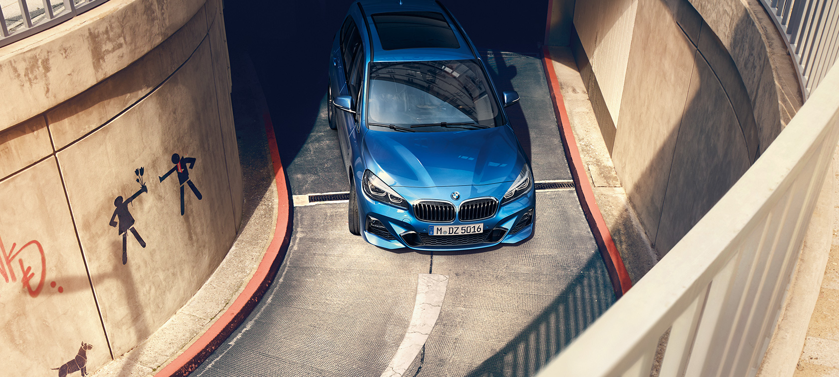 BMW 2 Series Gran Tourer driving in multi-storey car park BMW 2 Series Gran Tourer F46 Estoril Blue metallic bird’s-eye view driving in multi-storey car park