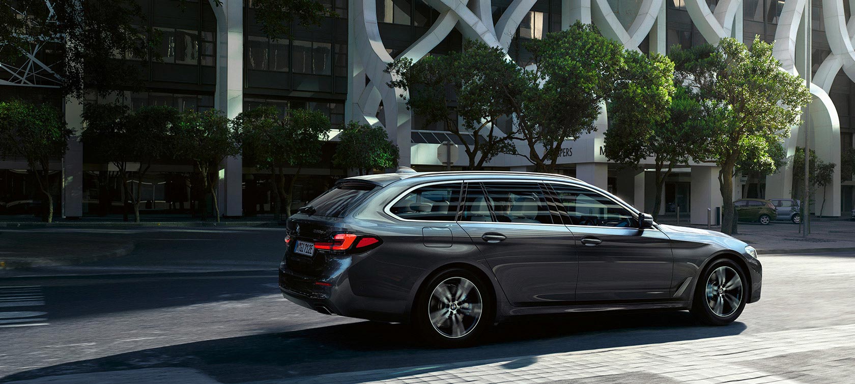 BMW 5 Series Touring G31 driving BMW 5 Series Touring G31 Facelift 2020 Sophisto Grey side view driving in city