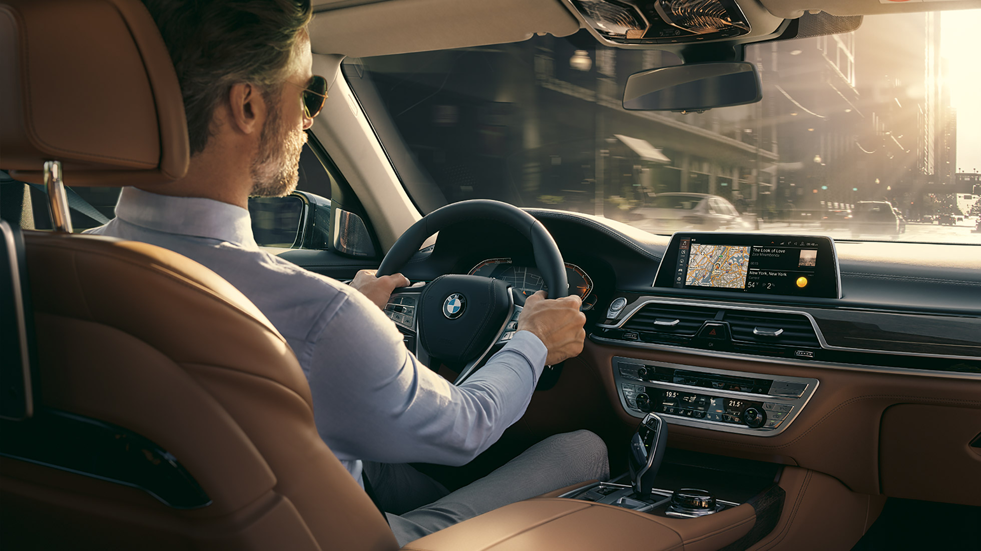 BMW 7 Series Sedan Connectivity features BMW 7 Series Sedan: man sits in BMW and uses Connectivity features