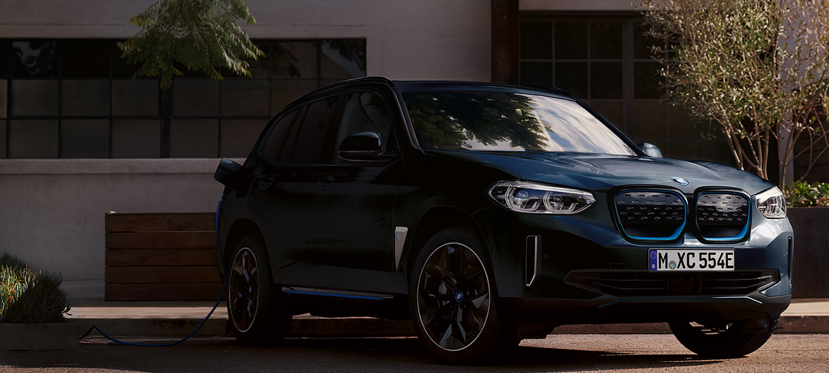 BMW iX3 Premier Edition G08 2020 high-gloss black three-quarter front view charging BMW iX3 Premier Edition G08 2020 high-gloss black three-quarter front view charging