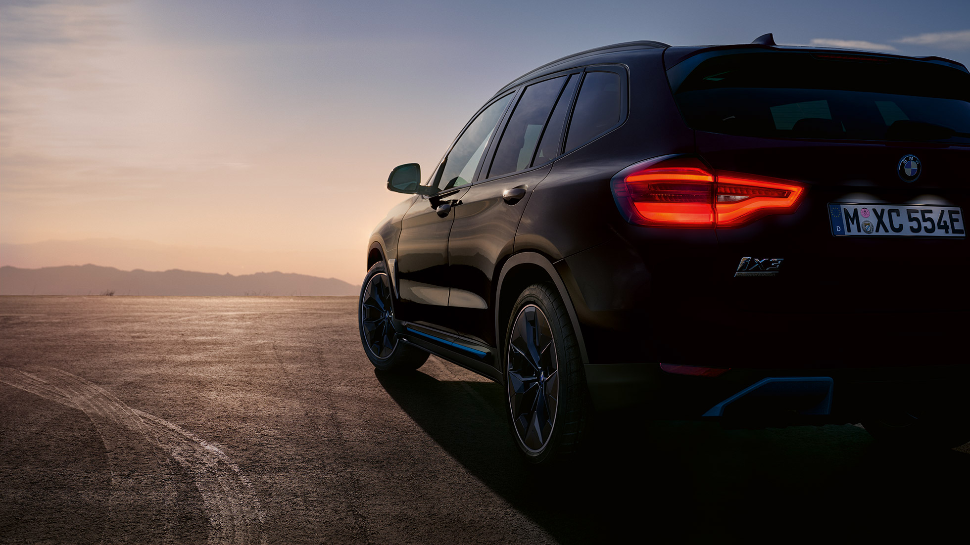 BMW iX3 G08 2020 High-gloss black three-quarter rear view on road BMW iX3 G08 2020 High-gloss black three-quarter rear view on road