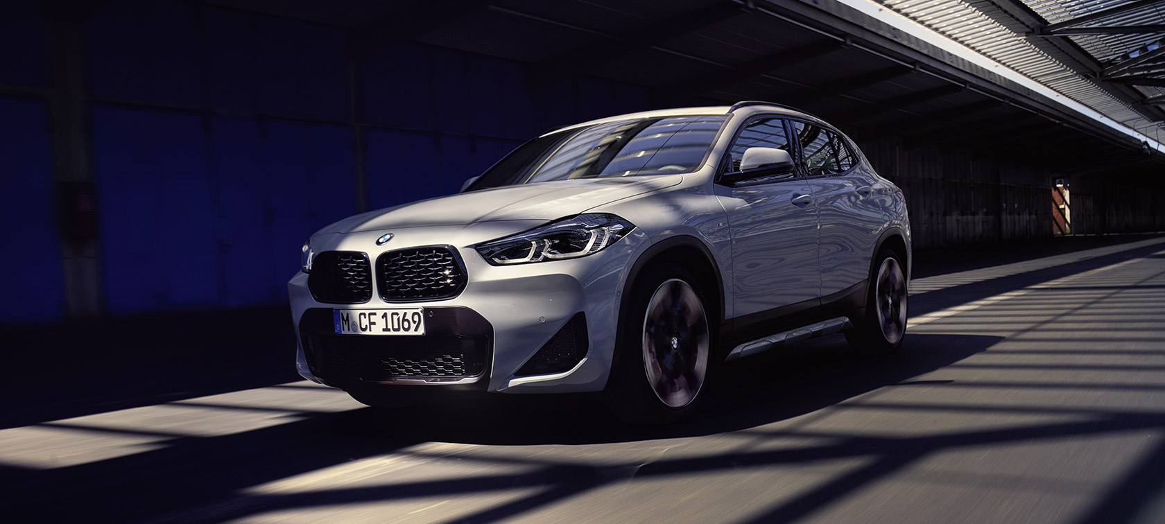 BMW X2 F39 Mesh Edition Brooklyn Grey three quarter front view in motion BMW X2 F39 Mesh Edition Brooklyn Grey three quarter front view in motion