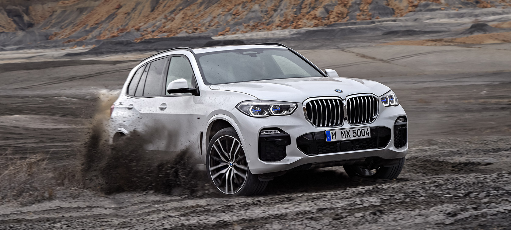 BMW X5 driving through rough terrain BMW X5 driving through rough terrain