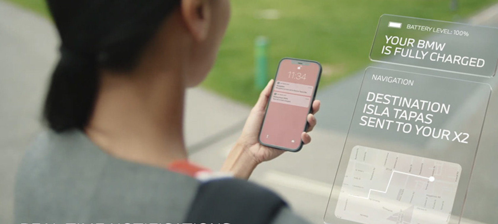 Download the My BMW App Woman checking the My BMW App on the phone