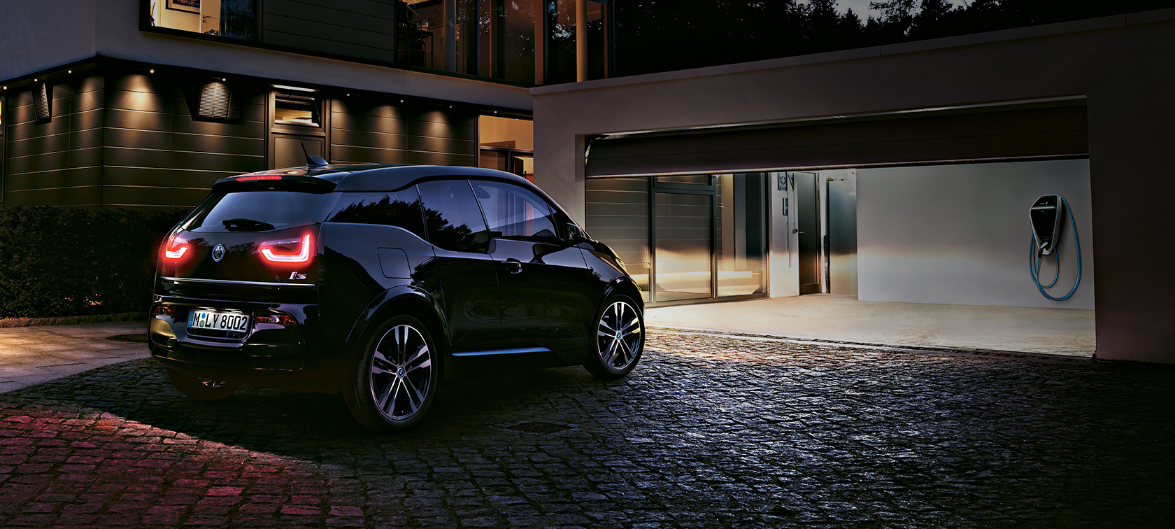 BMW i3 parked at a home BMW i3 parked at a home rear three-quarter view