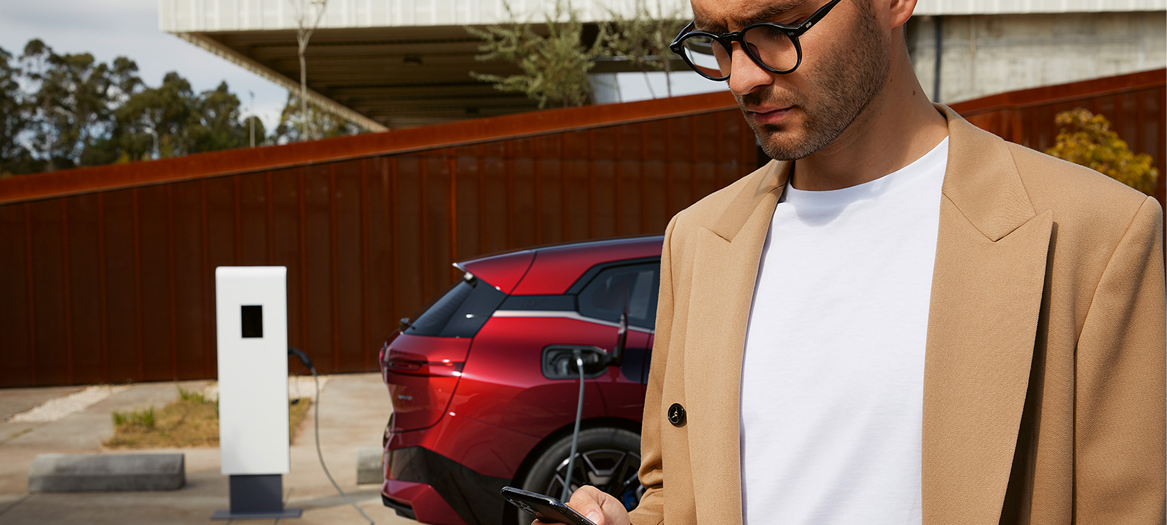 BMW iX i20 Adventurin Red at Public Charging station BMW iX i20 Adventurin Red at Public Charging station