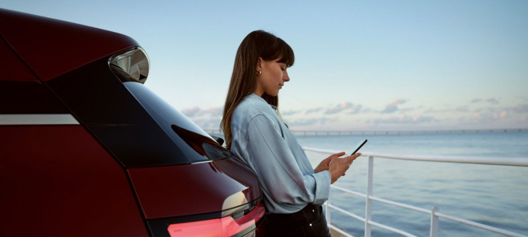 Download the My BMW App Woman checking the My BMW App on the phone