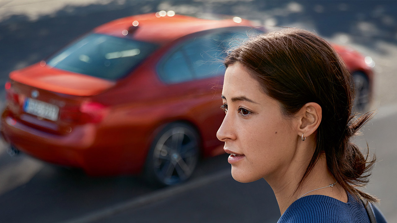 BMW Women at roadside with BMW Car.
